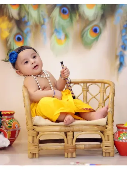 A playful, relaxed pose from a baby Krishna session. Our goal is to capture your child's natural curiosity and charm.