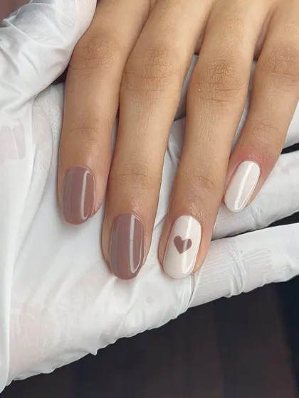 Nails that speak for themselves, no extensions needed. A lovely minimalist design with nude tones and a simple heart.