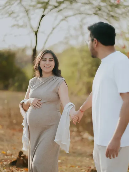 A beautiful shot of an expecting mother being led by her partner. This image symbolizes their journey into parenthood together, captured in soft, natural light.