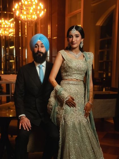 The elegant couple at their 'Mid-Century Mod' celebration. The decor, with its focus on organic forms and clean lines, was designed to enhance the venue's modern architecture and create a refined, glamorous atmosphere.