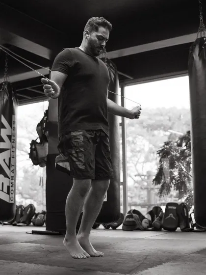 A black and white shot of a fighter skipping rope, focusing on rhythm and footwork.