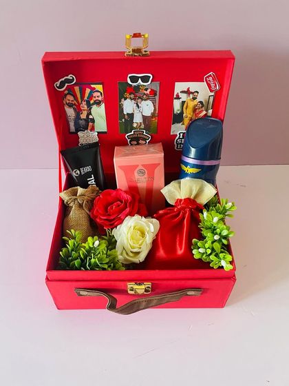 A Rakhi hamper designed for a brother and sister-in-law. I personalized the inside lid with their photos and filled the red suitcase box with grooming products and treats.