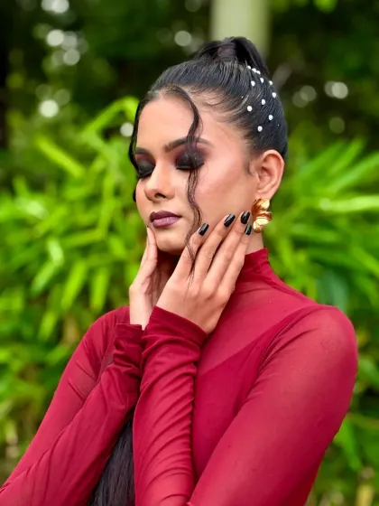 A close-up of the final makeup. The dark smokey eye, perfectly defined brows, and matte lipstick come together for a powerful glam look.