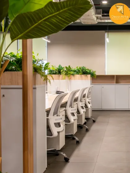 A modern workspace designed for tranquility and focus at the Brandman office. By integrating biophilic elements like raised planters into the open-plan layout, we create environments that enhance well-being and foster productivity.