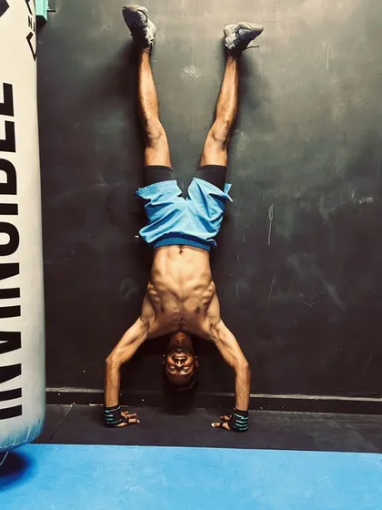 Getting comfortable being upside down. A wall-supported handstand is a key progression for building shoulder stability and core strength. This is a fundamental skill we teach on the path to more advanced inversions.