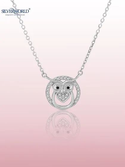 A whimsical owl pendant, symbolizing wisdom, is crafted with a zirconia-studded body and a heart detail. This charming necklace is a favorite among our younger customers.