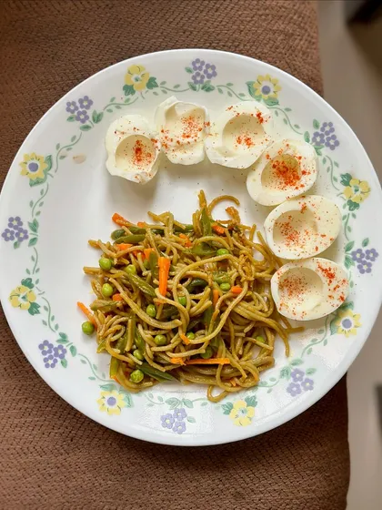 A simple meal of vegetable spaghetti with boiled eggs. Adding eggs is an easy way to increase the protein content of a carbohydrate-rich meal.