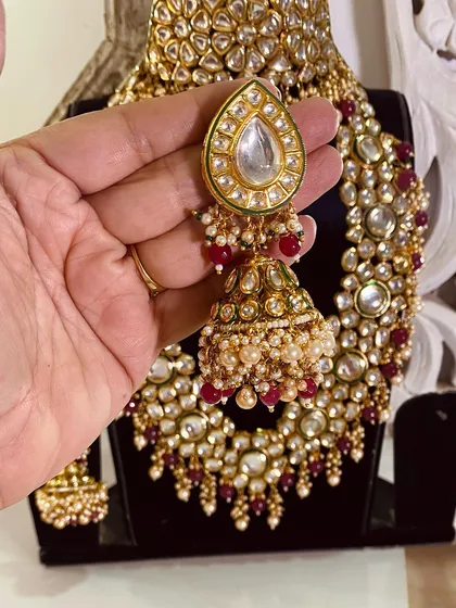 Another angle of the beautiful Kundan jhumka, showing the intricate pearl work. This is part of a complete bridal rental set.