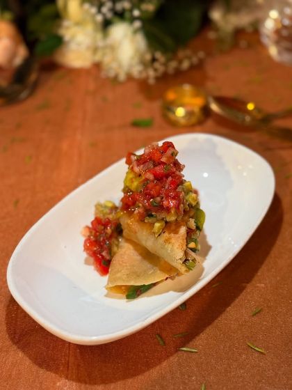 A simple yet elegant appetizer of crispy tortillas topped with a fresh avocado and tomato salsa. It's a perfect bite-sized taste of our commitment to fresh ingredients and clean flavours.