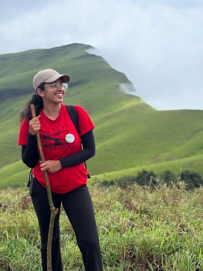 A happy trekker with her walking stick, ready to conquer the next leg of the Netravathi trail.