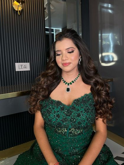 A serene moment captured, highlighting the beauty of the off-shoulder gown and the statement necklace.