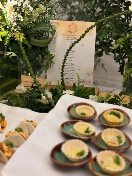 A platter of delicate mini quiches and veg tacos, part of the spread for The Thalasso Luxe launch. In the background, you can see the custom-printed menu I designed for the event.