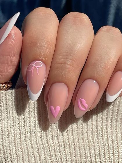 A sweet and subtle Valentine's look. This design features a classic French manicure with delicate 3D pink accents, including a tiny bow, heart, and lip shape for a touch of romance.