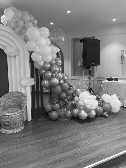 A detailed view of the balloon garland and arched backdrop from the baby shower setup.