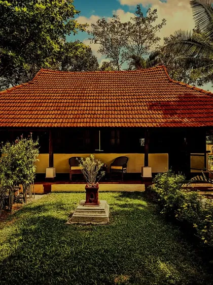 An 18th-century heritage wooden cottage, now a tranquil retreat for our guests. Surrounded by lush gardens, this accommodation offers an authentic experience, blending historical charm with the holistic practices of Ayurveda and yoga.