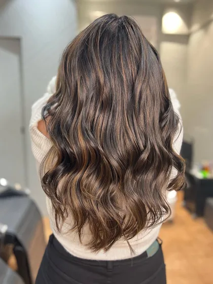 A golden bronze balayage that catches the light beautifully. This warm, metallic tone is perfect for making a statement.