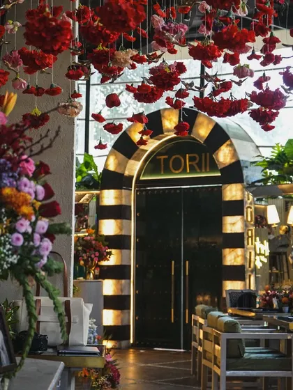 The entrance to the Mehndi venue, with its dramatic arch and ceiling of red flowers, promised a memorable celebration inside.
