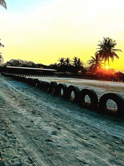 A serene view of our empty arena and track at sunset, a peaceful moment at the end of the day.