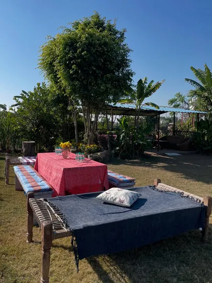 A rustic and colorful lunch setup at the farm. We use traditional charpoys and benches to create a relaxed, authentic atmosphere for daytime events.
