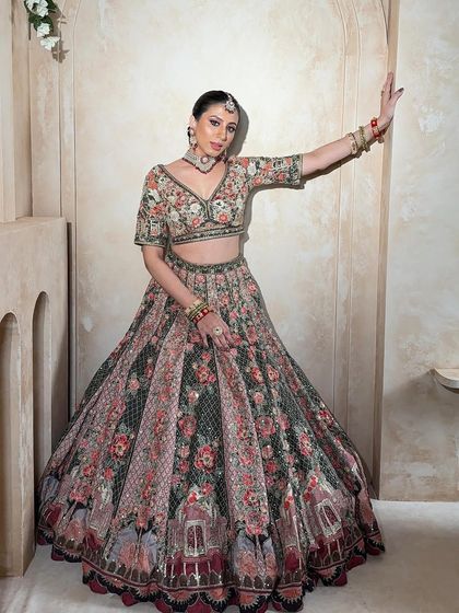 A full-length shot of the floral lehenga, showing its grand silhouette. This is a perfect rental piece for making a statement at any wedding event.