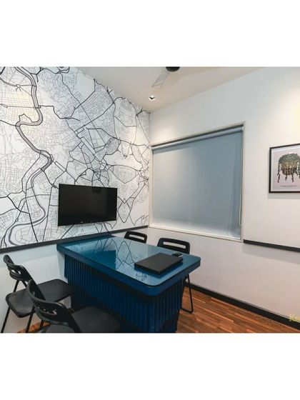 Our discussion room features a custom map wallpaper, reflecting our passion for architecture and place-making. It's a small, focused space for brainstorming sessions.