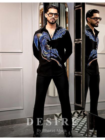 Sleek, bold, effortless. This full-length shot shows how the abstract wave shirt can command a room.