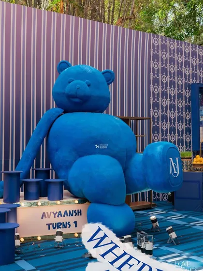 A giant, custom-made blue teddy bear, monogrammed with the birthday boy's initials, makes for an unforgettable statement piece. This bespoke prop is a client favorite for first birthdays and baby showers.