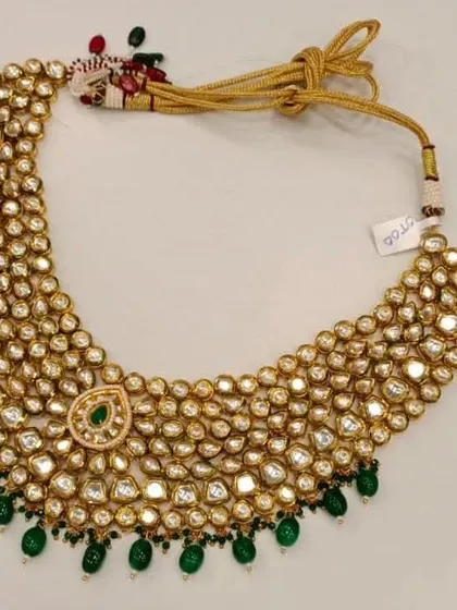 Here is a detailed product shot of the multi-row Kundan necklace worn by the bride. The uncut Polki style gives it an authentic, luxurious feel.