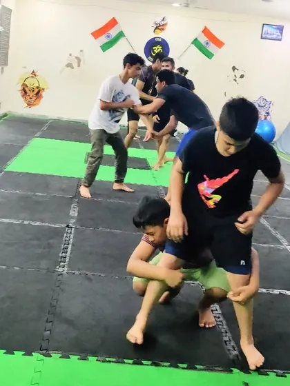 A snapshot from our summer camp, focusing on wrestling and grappling drills. Learning to control an opponent on the ground is a vital self-defense skill.