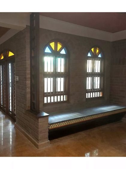 A duplicate of the room with the built-in window seat and arched windows.