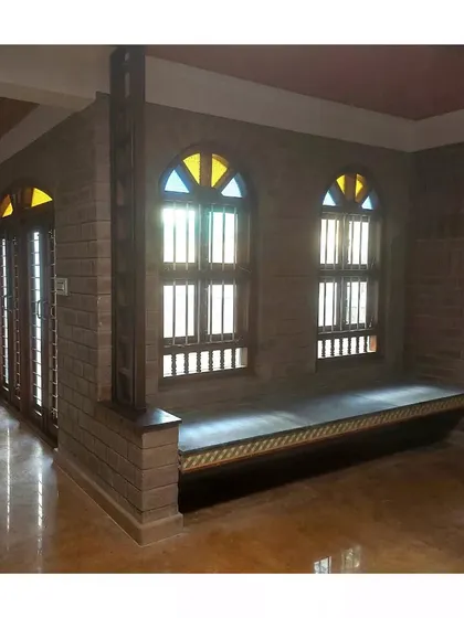 A duplicate of the room with the built-in window seat and arched windows.