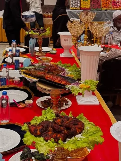 A long view of the Shahi Table, showcasing the elegant seating and the abundance of food served, including our famous Tandoori Chicken and Fish Fry.