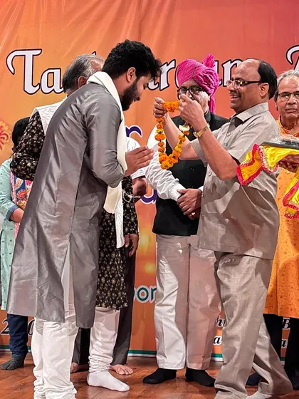 Being felicitated with a traditional garland at the award ceremony.