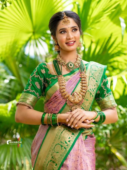 A full-length view of a model in a stunning silk saree, highlighting the rich fabric and the elegance of her pose.