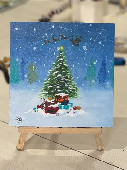 A beautiful Christmas-themed painting on a mini canvas. This winter scene, complete with Santa's sleigh, was created during our holiday celebration.