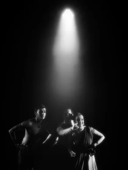 A black and white shot of the 'Nagamandala' cast under a single spotlight. This creates a feeling of suspense and drama, drawing the audience into a pivotal moment.