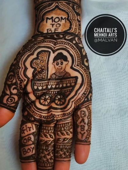 A close up of a baby shower mehendi palm. This design features a cute baby in a cradle with "Mom to be" written above, perfect for celebrating the occasion.