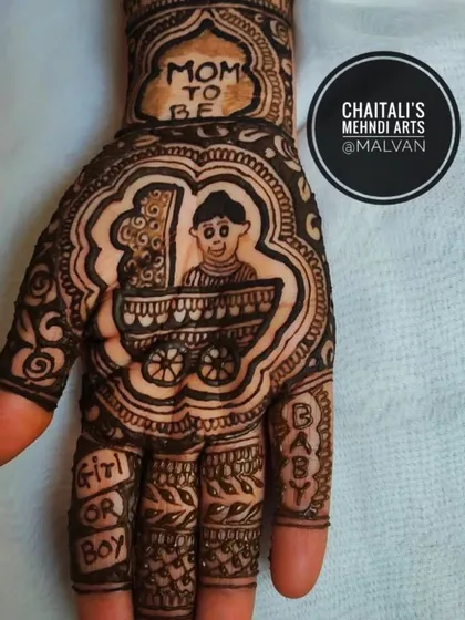 A close up of a baby shower mehendi palm. This design features a cute baby in a cradle with "Mom to be" written above, perfect for celebrating the occasion.