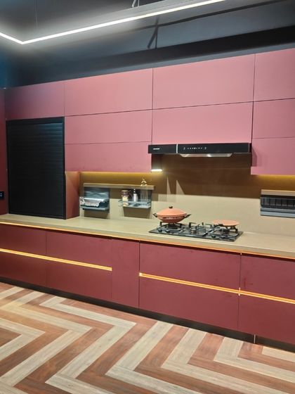 Another angle of the magenta kitchen, showing the seamless integration of the rolling shutter and upper cabinets. The design ensures every inch of space is utilized effectively.