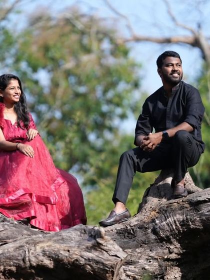 A relaxed and stylish pre-wedding photo. This couple looks effortlessly cool, with the red organza gown adding a pop of color and texture.