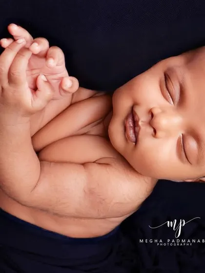 A beautiful, sleepy smile. These are the candid moments that make each newborn session so special.