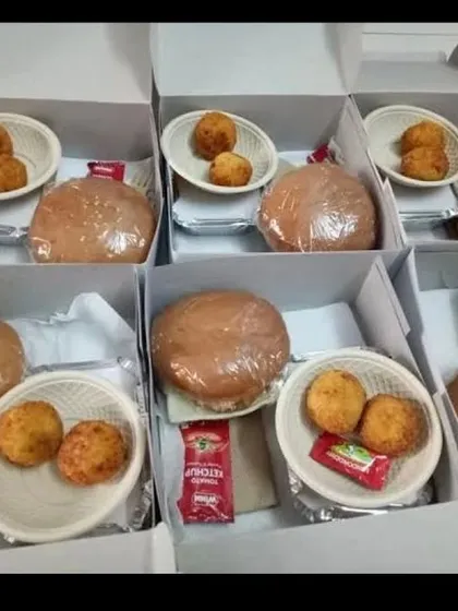 We assemble each snack box with care to ensure freshness and neat presentation. This option includes a wrapped veg burger and cheese corn nuggets, perfect for kids' parties or corporate family days.