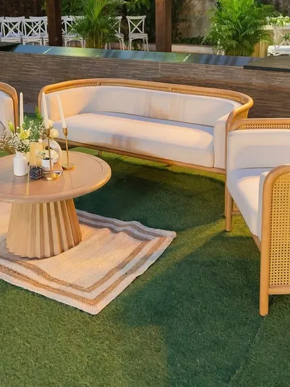 A chic and modern lounge area with cane furniture and neutral tones. This cozy corner provided a comfortable and stylish space for guests to relax and mingle.