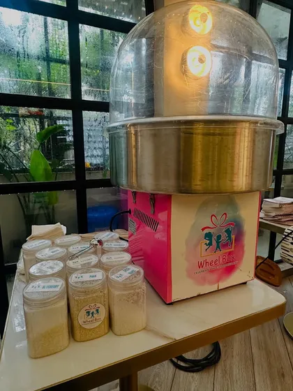 A close-up of our cotton candy machine and the variety of organic sugar flavors we bring to each event, ready to be spun into delicious treats.