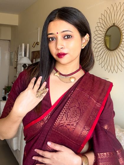 A detailed shot of the copper statement jewellery I chose for my puja look. The intricate design of the necklace and ring adds an artisanal touch to the traditional saree.