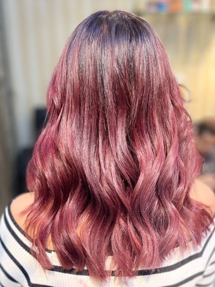 Fall in love with your hair again with this cherry red balayage. It's a head-turning look that's perfect for making a statement.