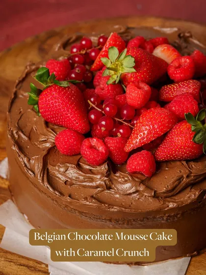 My Belgian Chocolate Mousse Cake with Caramel Crunch, often topped with fresh berries for a seasonal twist.