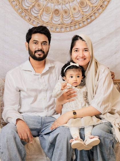 A warm and loving family portrait in our boho-chic setup. The natural textures and neutral colors create a cozy and inviting atmosphere.
