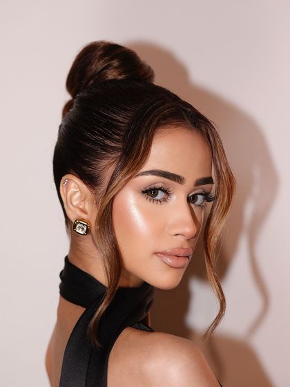 A beautiful profile shot that captures the glow and softness of the makeup.