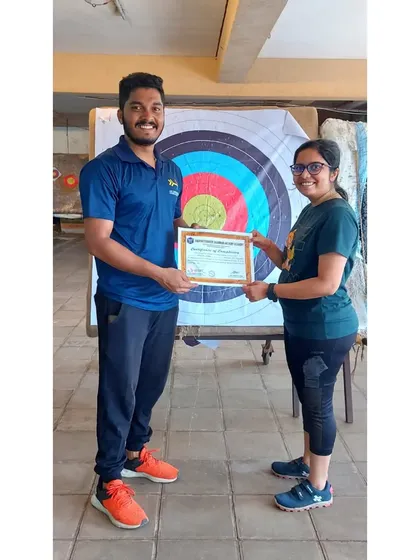 A student from the August 2023 batch receiving her certificate. She mastered the basics of stance and aiming.